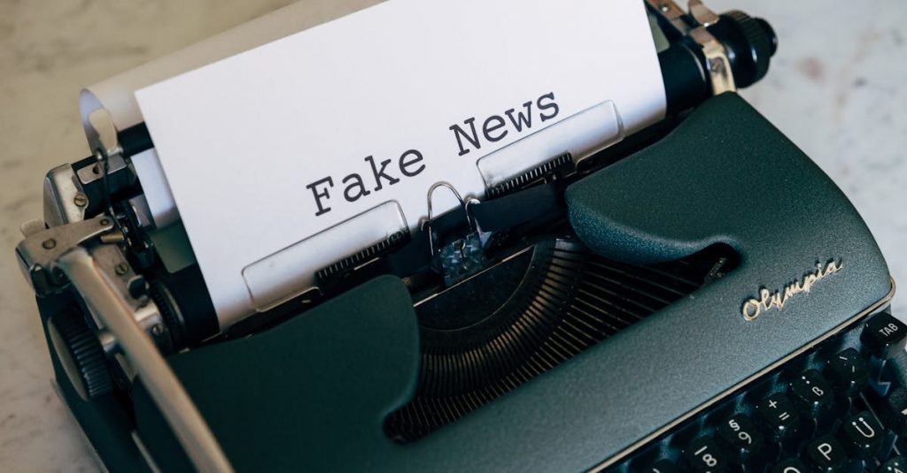 Close-up of a vintage typewriter displaying the words 'Fake News' on paper.